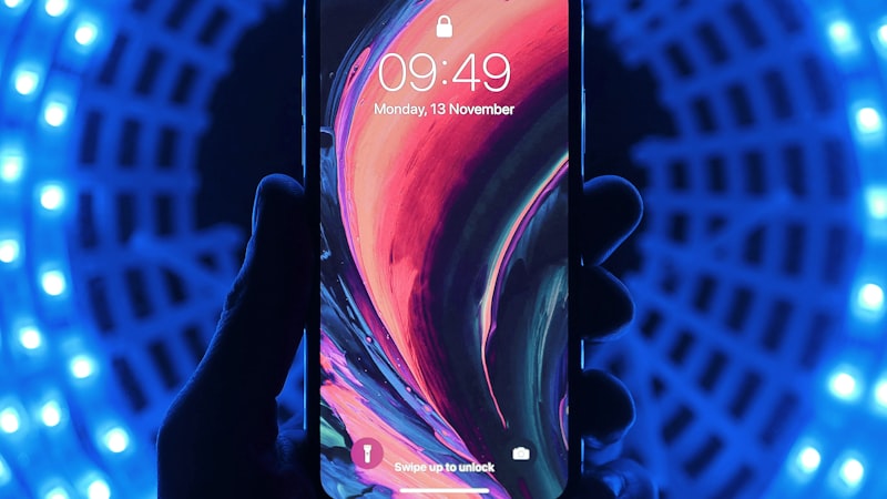 Person holding iPhone displaying colorful screen